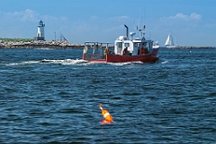 Lobsterboat Passes by Straitsmouth Island Lighthouse